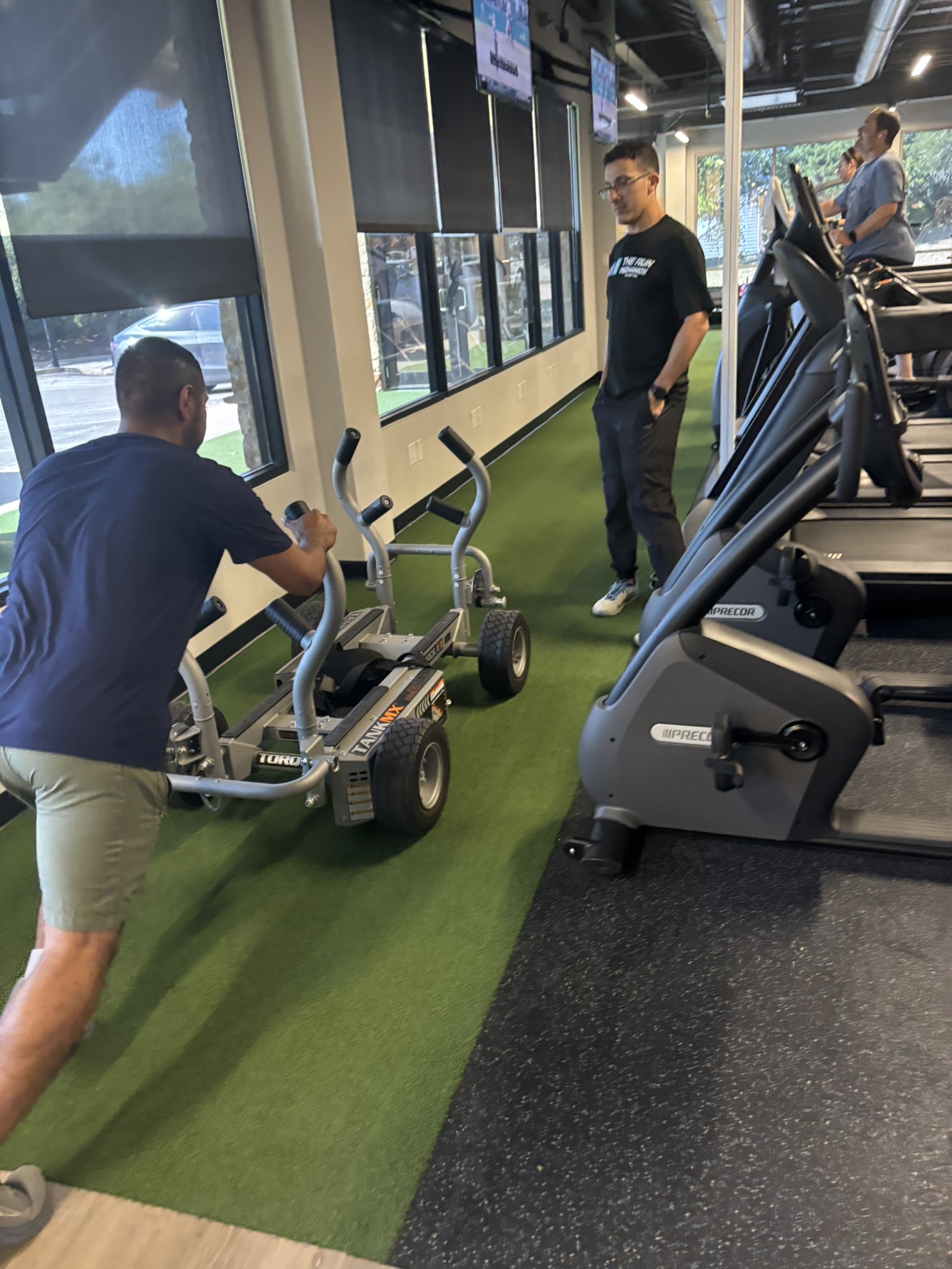 Athlete pushing a weighted sled during a performance session
